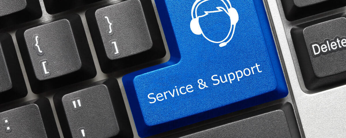 A close-up of a black keyboard where the enter key has been replaced with a blue button that says "Service and Support."